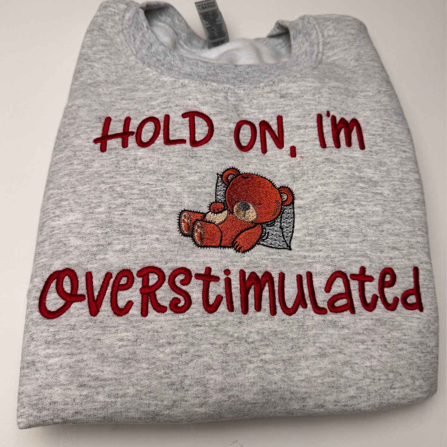 Embroidered Hold on I'm Over Stimulated Sleepy Bear Crewneck Sweatshirt