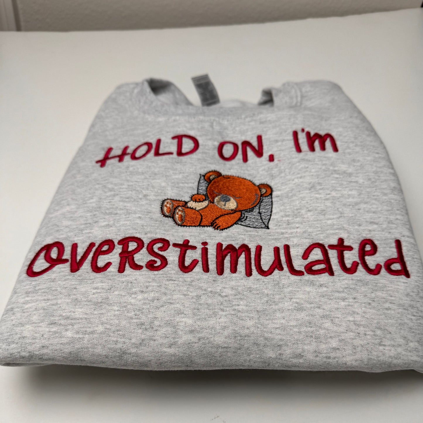 Embroidered Hold on I'm Over Stimulated Sleepy Bear Crewneck Sweatshirt