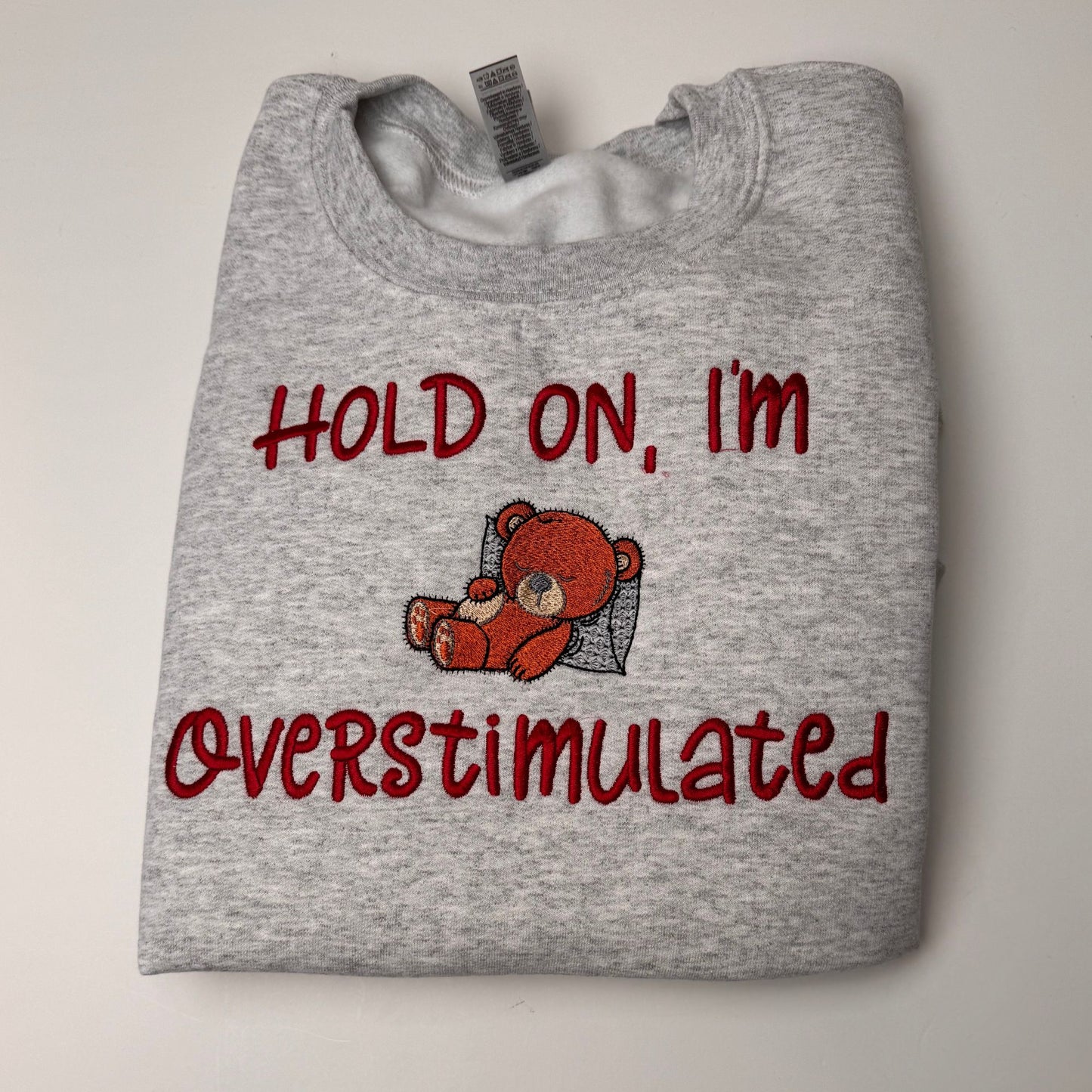 Embroidered Hold on I'm Over Stimulated Sleepy Bear Crewneck Sweatshirt