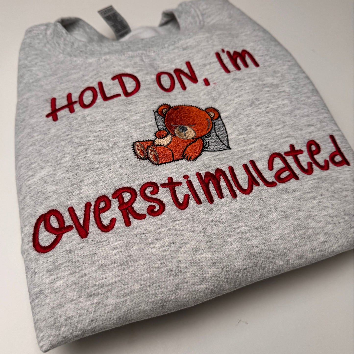 Embroidered Hold on I'm Over Stimulated Sleepy Bear Crewneck Sweatshirt